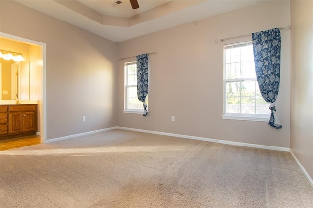 interior space featuring light colored carpet, a healthy amount of sunlight, and ceiling fan