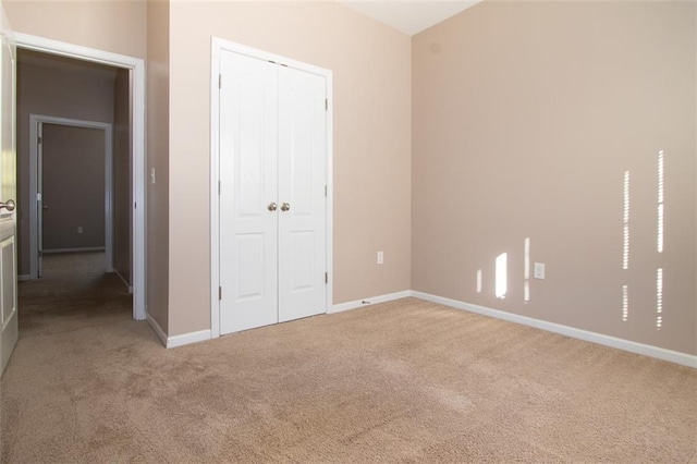 unfurnished bedroom with carpet and a closet