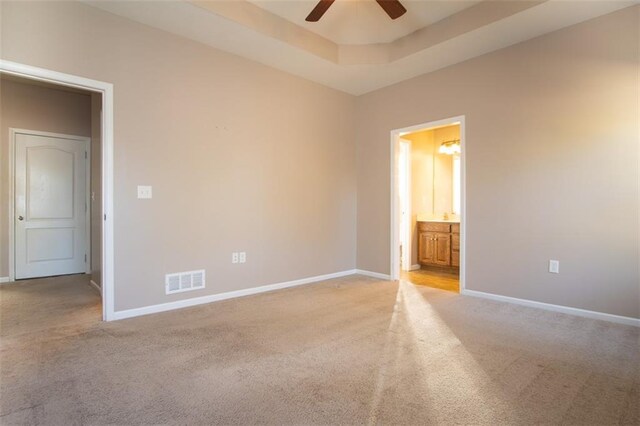 spare room featuring light colored carpet and ceiling fan