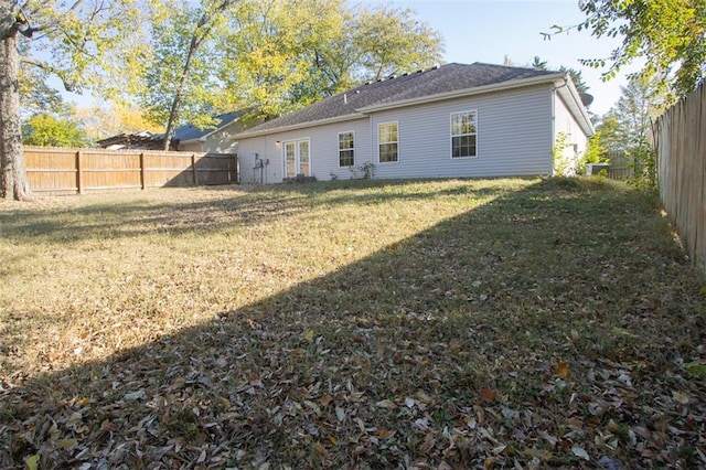 rear view of house with a lawn