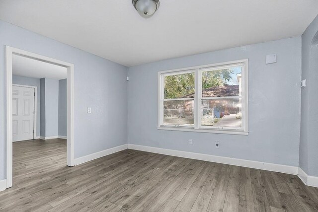 446 Montgall Ave, Kansas City, MO 64124 - unfurnished room featuring wood finished floors and baseboards