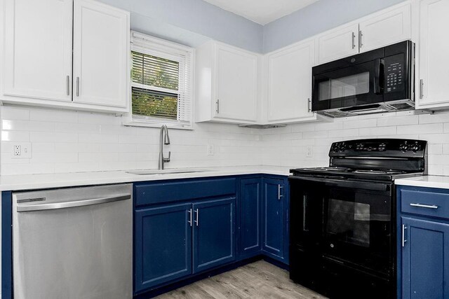 446 Montgall Ave, Kansas City, MO 64124 - kitchen featuring black appliances, blue cabinetry, a sink, light countertops, and light wood-type flooring