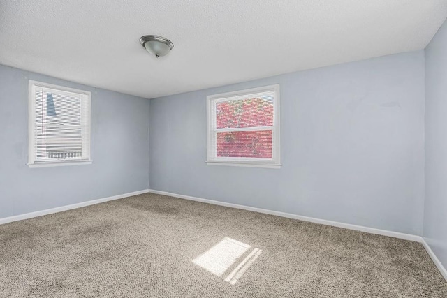446 Montgall Ave, Kansas City, MO 64124 - carpeted spare room featuring healthy amount of natural light and baseboards