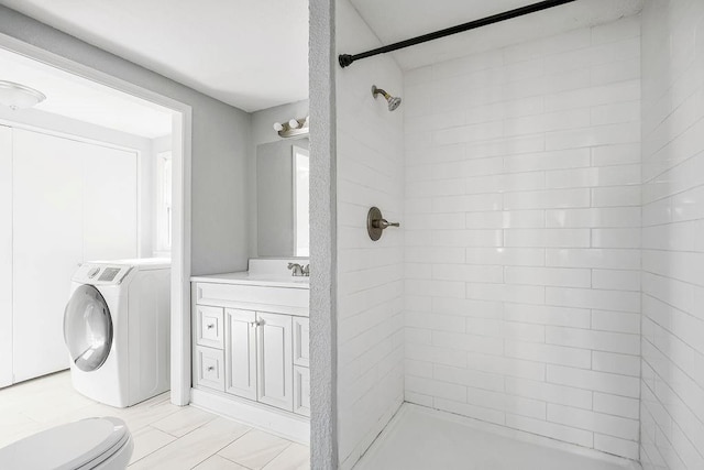 446 Montgall Ave, Kansas City, MO 64124 - bathroom with washer / clothes dryer, vanity, and tiled shower