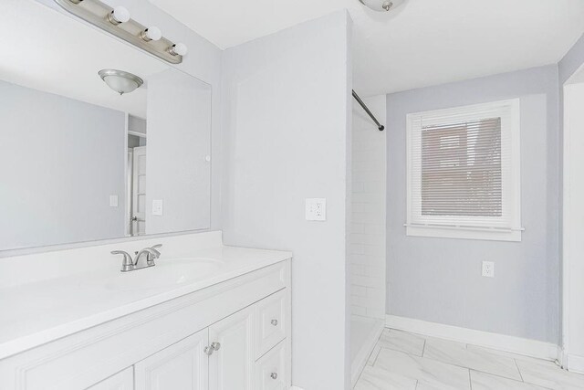 446 Montgall Ave, Kansas City, MO 64124 - full bathroom featuring a shower, baseboards, marble finish floors, and vanity