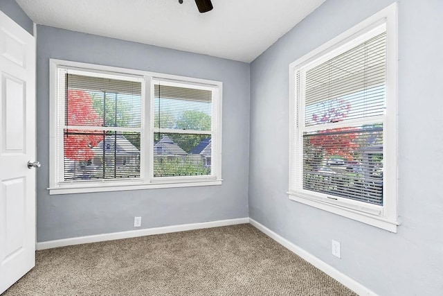 446 Montgall Ave, Kansas City, MO 64124 - carpeted spare room with baseboards and a ceiling fan