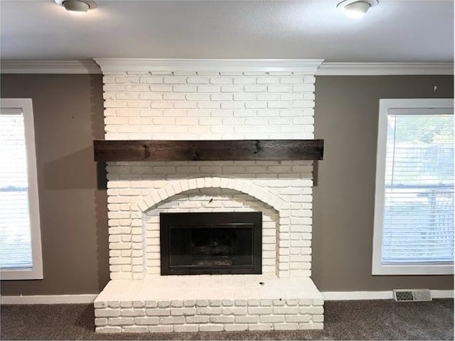 room details featuring carpet floors, a brick fireplace, and ornamental molding