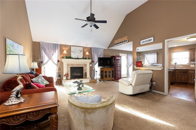 living room with carpet flooring, ceiling fan, and high vaulted ceiling