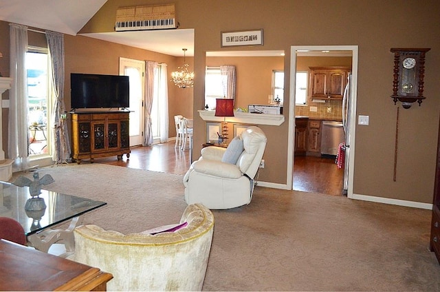 living room featuring hardwood / wood-style flooring, a notable chandelier, and lofted ceiling