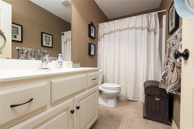 bathroom featuring tile patterned floors, vanity, and toilet