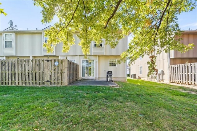 rear view of property with a patio area and a yard