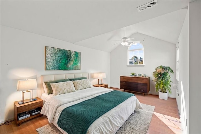 bedroom with light wood-type flooring, vaulted ceiling, and ceiling fan