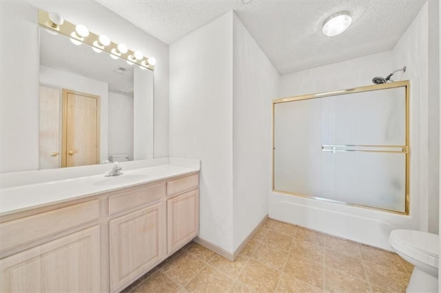 full bathroom featuring shower / bath combination with glass door, vanity, a textured ceiling, and toilet