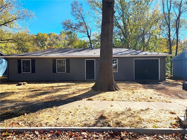 back of property featuring a garage