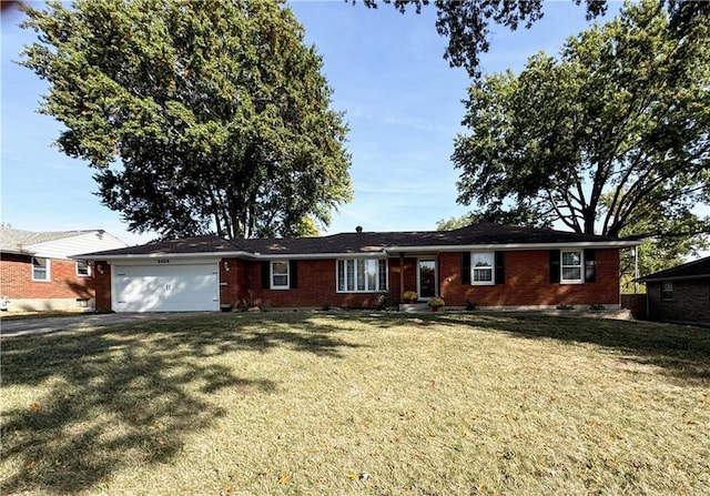 ranch-style home featuring a front yard and a garage