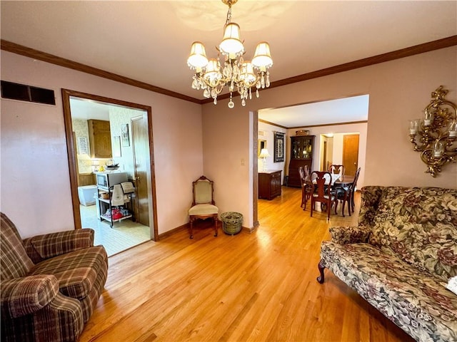 living room featuring ornamental molding, an inviting chandelier, and hardwood / wood-style floors