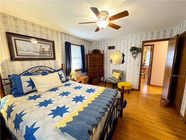 bedroom featuring hardwood / wood-style flooring and ceiling fan