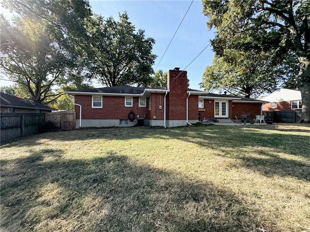 back of house with a lawn