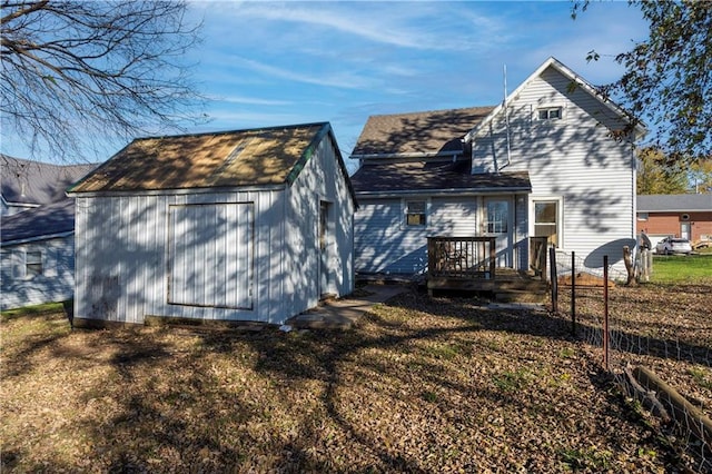 rear view of house featuring a shed and a lawn