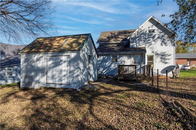 605 N Ardinger St, Hamilton, MO 64644 - rear view of house with a shed, an outbuilding, a wooden deck, and fence