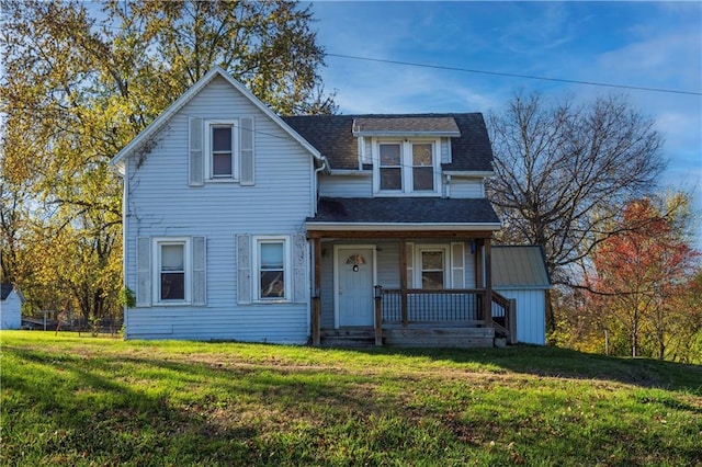 view of front of home featuring covered porch and a front lawn