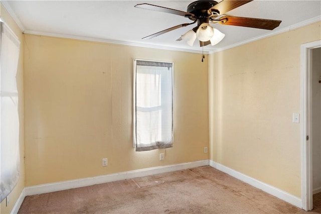 empty room featuring light carpet, ceiling fan, and crown molding