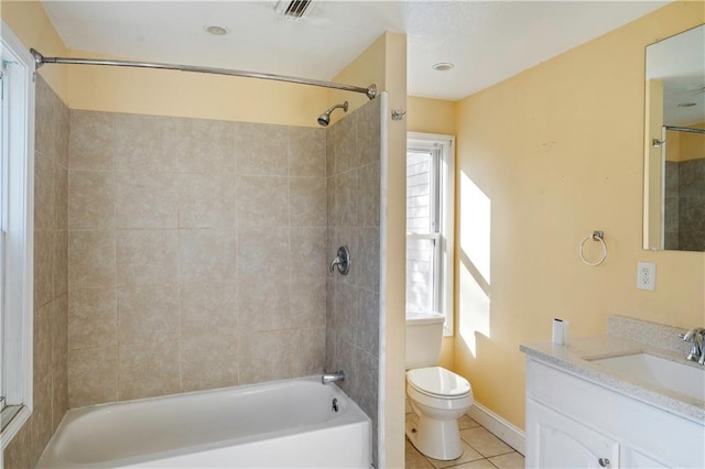 full bathroom with toilet, tiled shower / bath combo, vanity, and tile patterned flooring