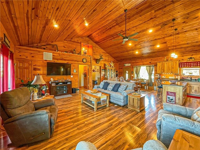 living room featuring wood-type flooring, high vaulted ceiling, ceiling fan, and wooden ceiling