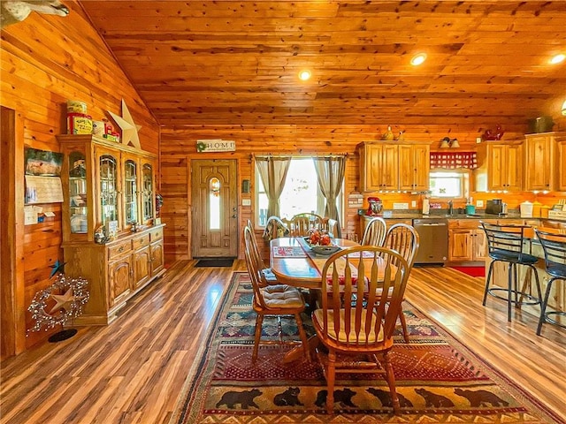 dining room featuring dark hardwood / wood-style floors, vaulted ceiling, wood walls, and wood ceiling