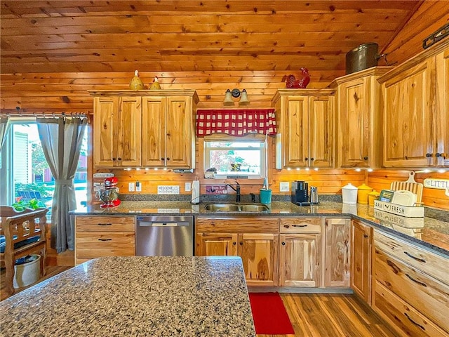 kitchen with dishwasher, light wood-type flooring, wooden walls, and a healthy amount of sunlight