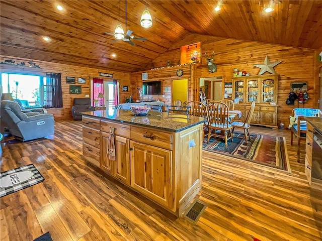 kitchen with wood walls, wooden ceiling, dark wood-type flooring, and vaulted ceiling