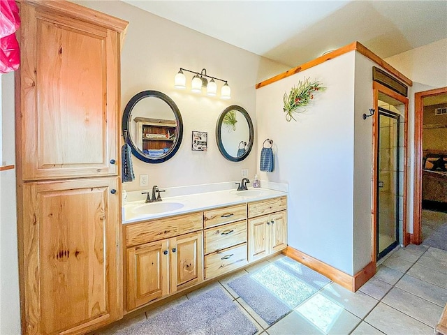 bathroom with tile patterned flooring, vanity, and an enclosed shower