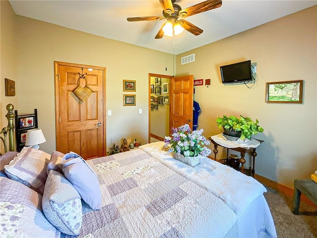 bedroom featuring ceiling fan and carpet