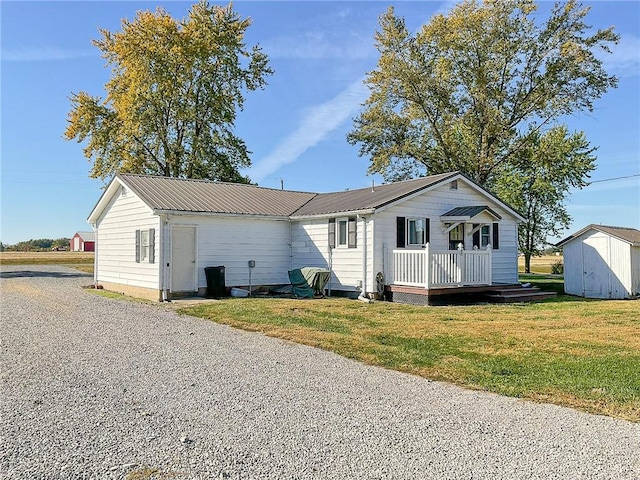 exterior space featuring a front lawn and a shed