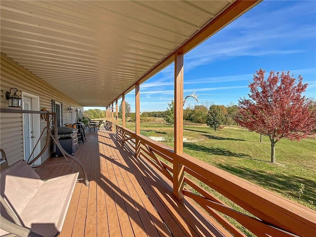 wooden terrace with a yard and a porch