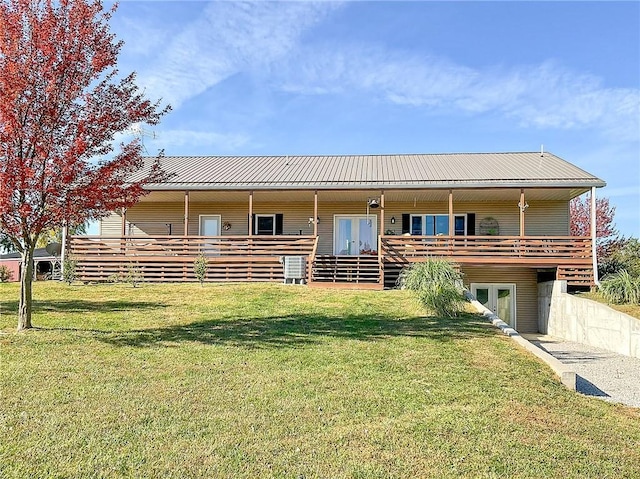 view of front of home featuring french doors and a front lawn