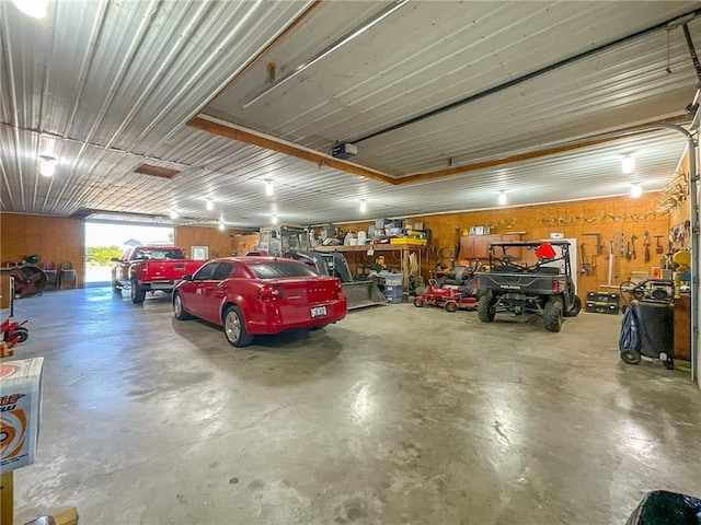 garage featuring wood walls and a garage door opener