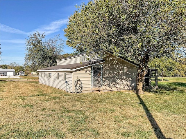 view of side of home with a lawn