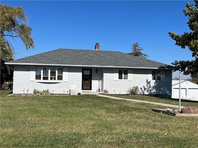 ranch-style house with a garage and a front lawn