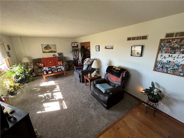 living room with hardwood / wood-style floors and a textured ceiling