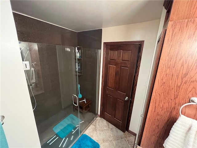 bathroom featuring a shower with shower door