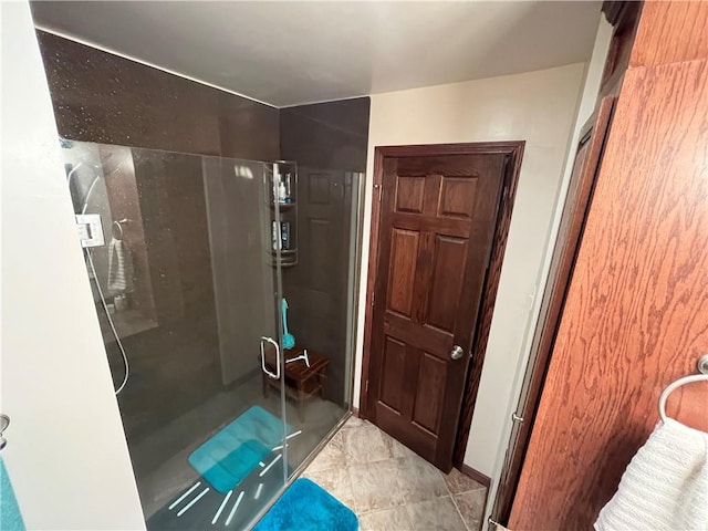 bathroom featuring a shower with shower door