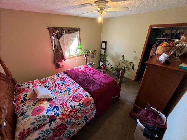 bedroom featuring ceiling fan, a textured ceiling, and dark colored carpet