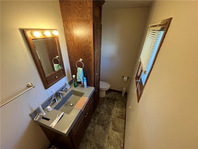 bathroom featuring toilet and vanity