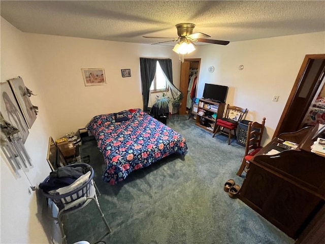 carpeted bedroom with ceiling fan and a textured ceiling