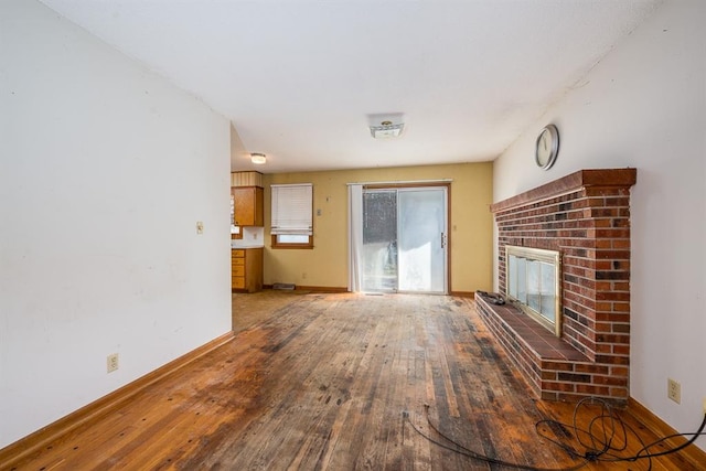 unfurnished living room featuring a fireplace and hardwood / wood-style flooring