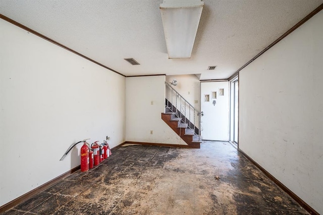 interior space featuring crown molding and a textured ceiling