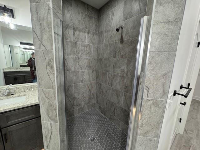 bathroom with vanity and tiled shower