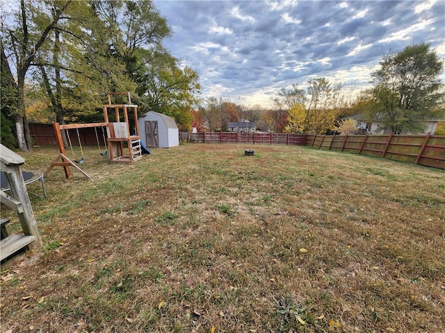 view of yard with a shed and a playground