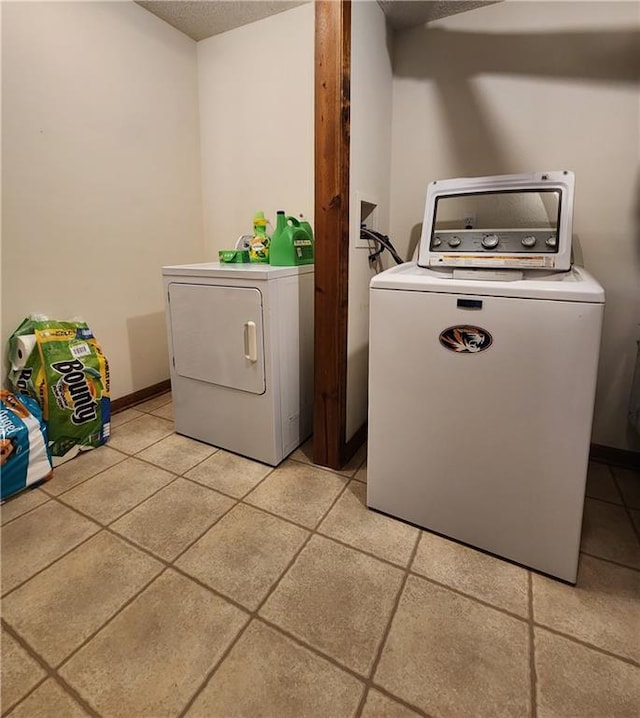 clothes washing area featuring washer and clothes dryer